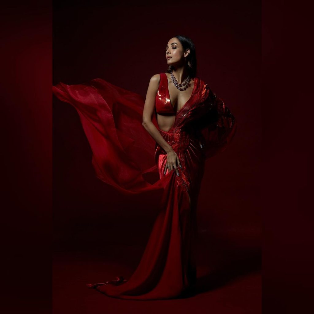  Malaika Arora passes sultry vibes in a crimson-red saree. (Image: Instagram)